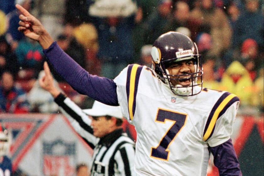 Then-Vikings quarterback Randall Cunningham gestures during a game on Dec. 27, 1997.