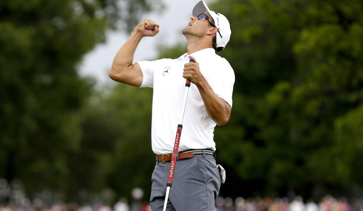 Adam Scott begins to celebrate after sinking the winning putt on the third playoff hole at Colonial on Sunday.
