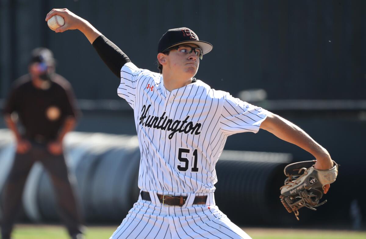 Huntington Beach pitcher Matthew Lopez throws in a game vs. Edison at home on Wednesday, March 31, 2021.