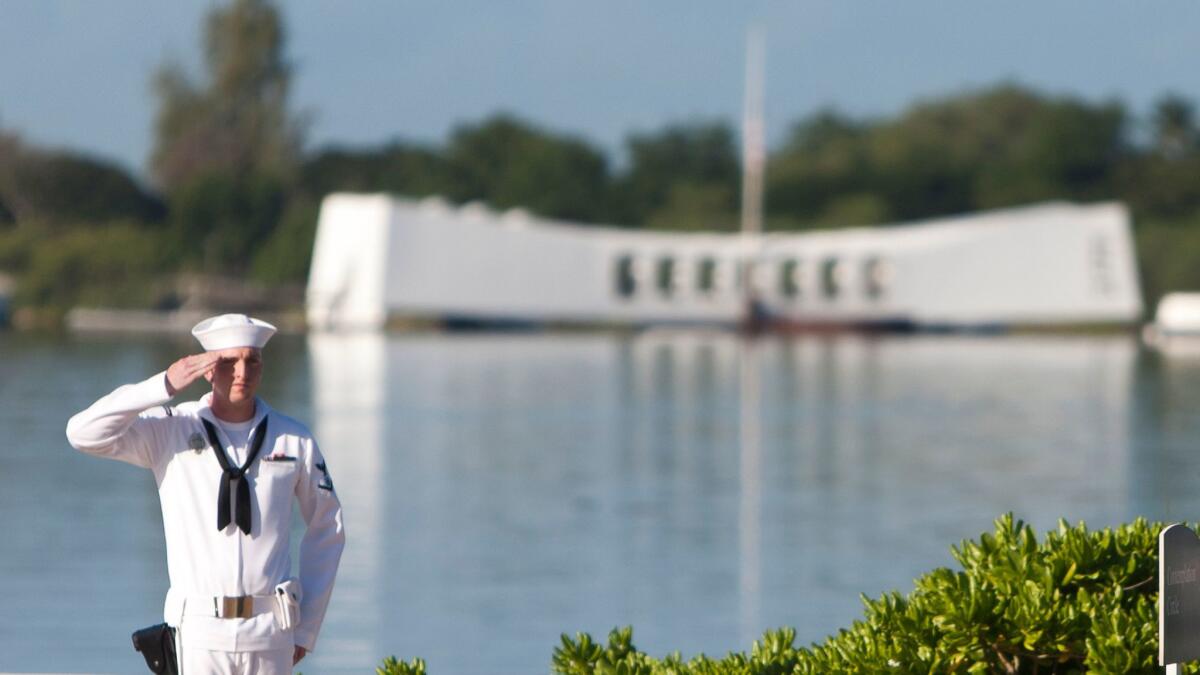 Navy rifleman standing at attention by the USS Arizona.