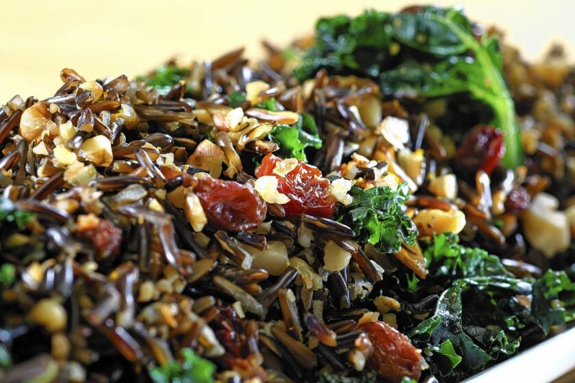 Sweet raisins complement the flavors of a kale and wild rice salad with walnuts.