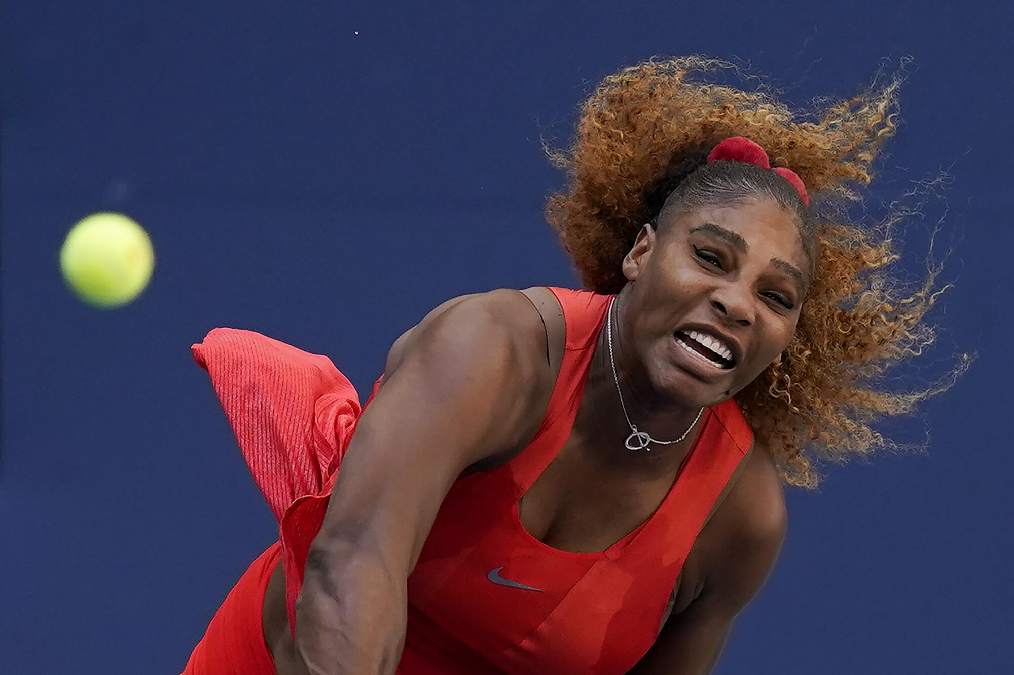 Serena Williams hits a serve during a match.