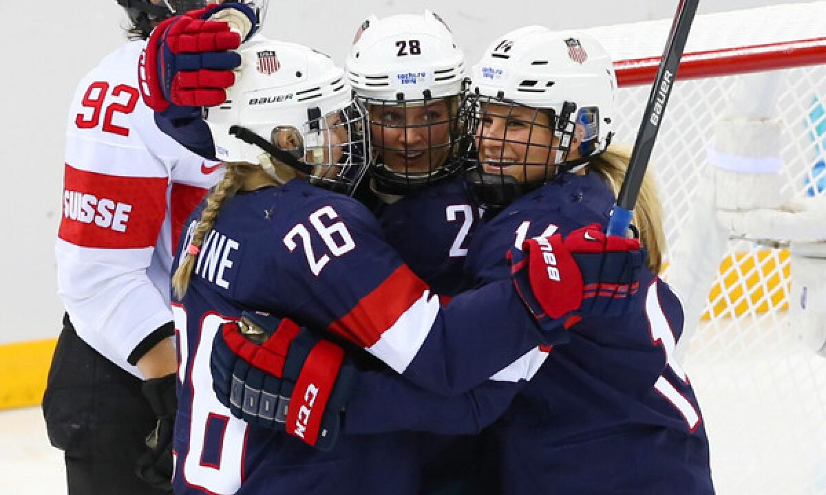 Team USA's Amanda Kessel, center, celebrates with teammates Kendall Coyne, left, and Brianna Decker after scoring a goal in a 9-0 blowout victory over Switzerland on Monday.