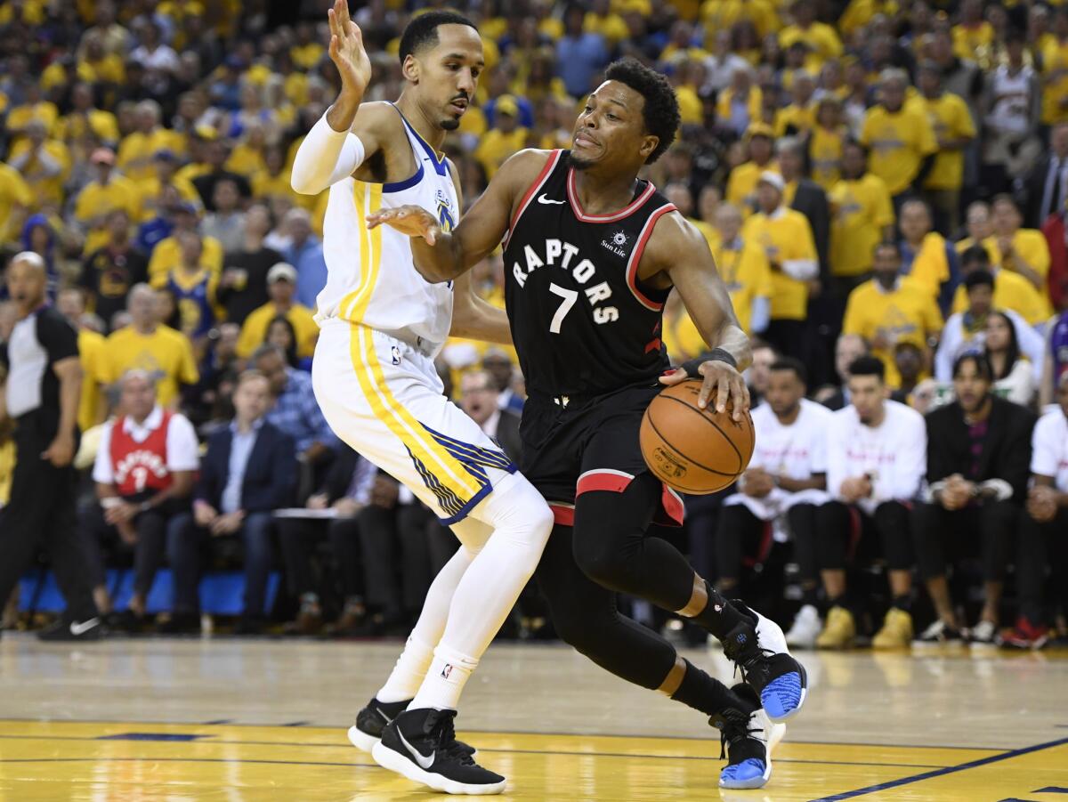 Toronto Raptors guard Kyle Lowry (7) tries to move around Golden State Warriors guard Shaun Livingston during the second half of Game 3 of the NBA Finals on Wednesday in Oakland.