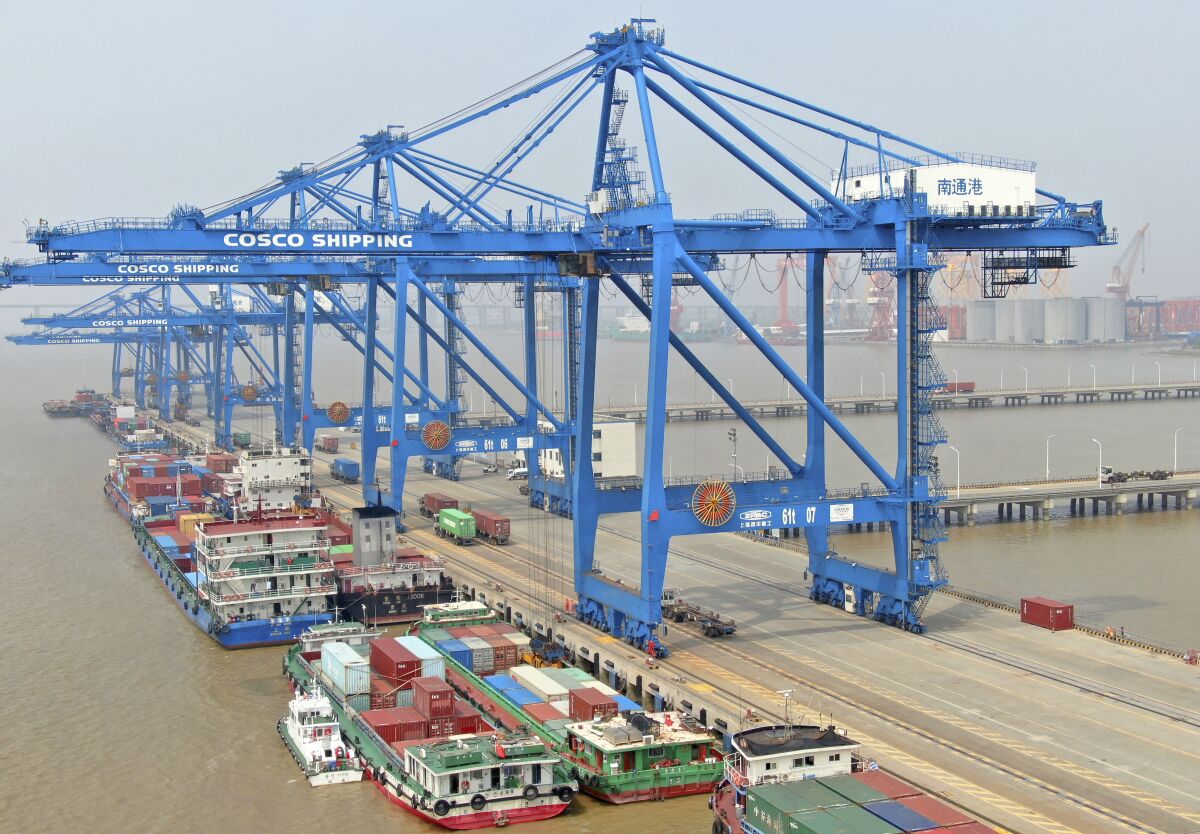 In this aerial photo, container ships are docked at a port on the Yangtze River in Nantong in eastern China's Jiangsu Province, Monday, Sept. 6, 2021. China's import and export growth accelerated in August despite disruptions due to the spread of the coronavirus's delta variant. (Chinatopix via AP)
