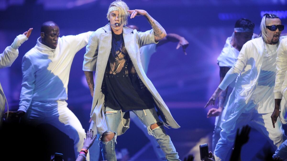 A woman was arrested on suspicion of trespassing after she allegedly walked into Justin Bieber's hotel room in Laguna Beach on Tuesday. The pop star is pictured in this file photo during a performance at Staples Center in 2016.