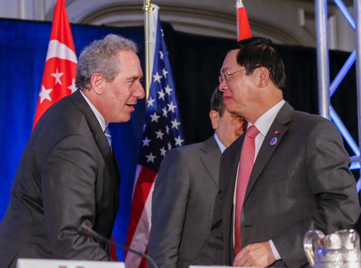 United States Trade Representative Michael Froman greets Vietnam Minister of Industry and Trade Vu Huy Hoang after the twelve Trans-Pacific Partnership member countries met in Atlanta, Georgia on Oct. 5.