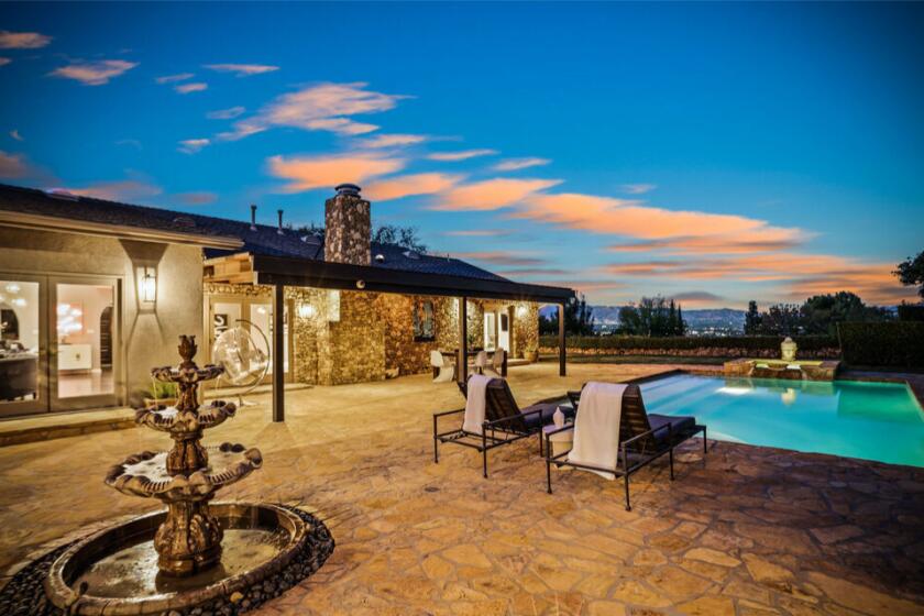 The half-acre estate includes a ranch-style main house, custom guesthouse and a patio and pool overlooking the San Fernando Valley.