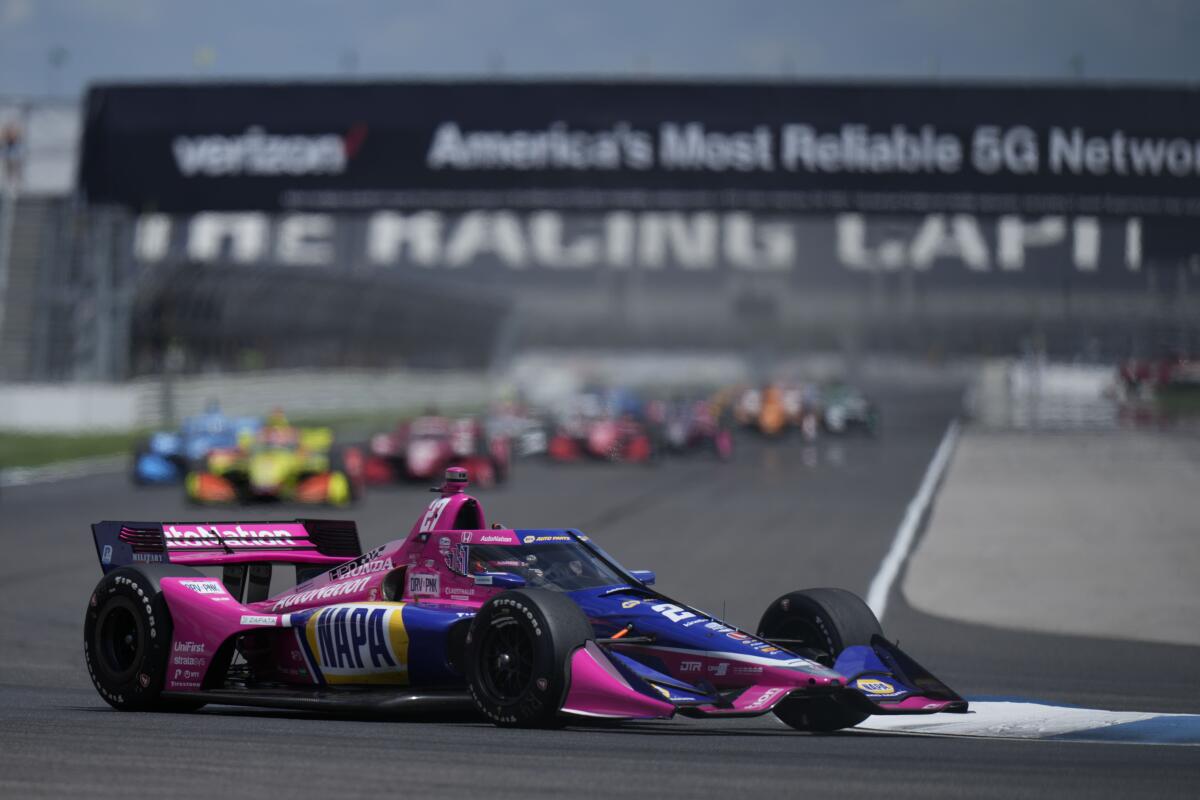 IndyCar driver Alexander Rossi leads the field into a turn on the road course at Indianapolis Motor Speedway.
