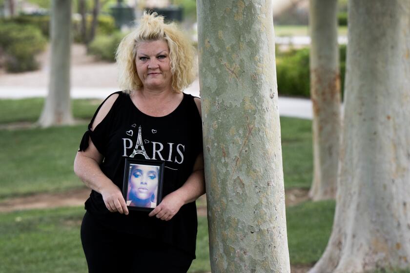 LAS VEGAS NV MAY 23, 2023 - Jill Harrison poses with a photograph of her daughter Ciara Harrison at a Las Vegas park on Tuesday, May 23, 2023. Ciara, 25 years old at the time, was murdered by an acquaintance in Riverside County in 2019. (David Becker/For the Times)