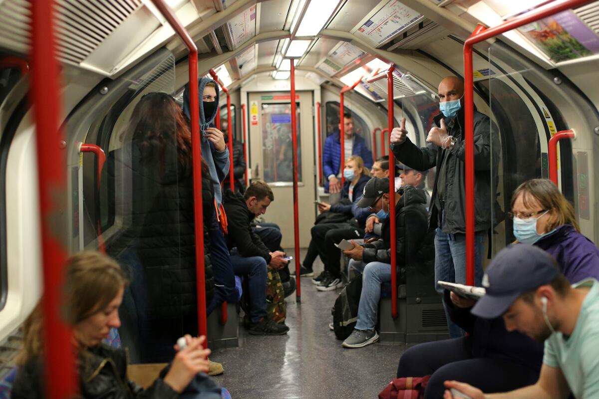 Some commuters in London wear masks on an underground train last week.