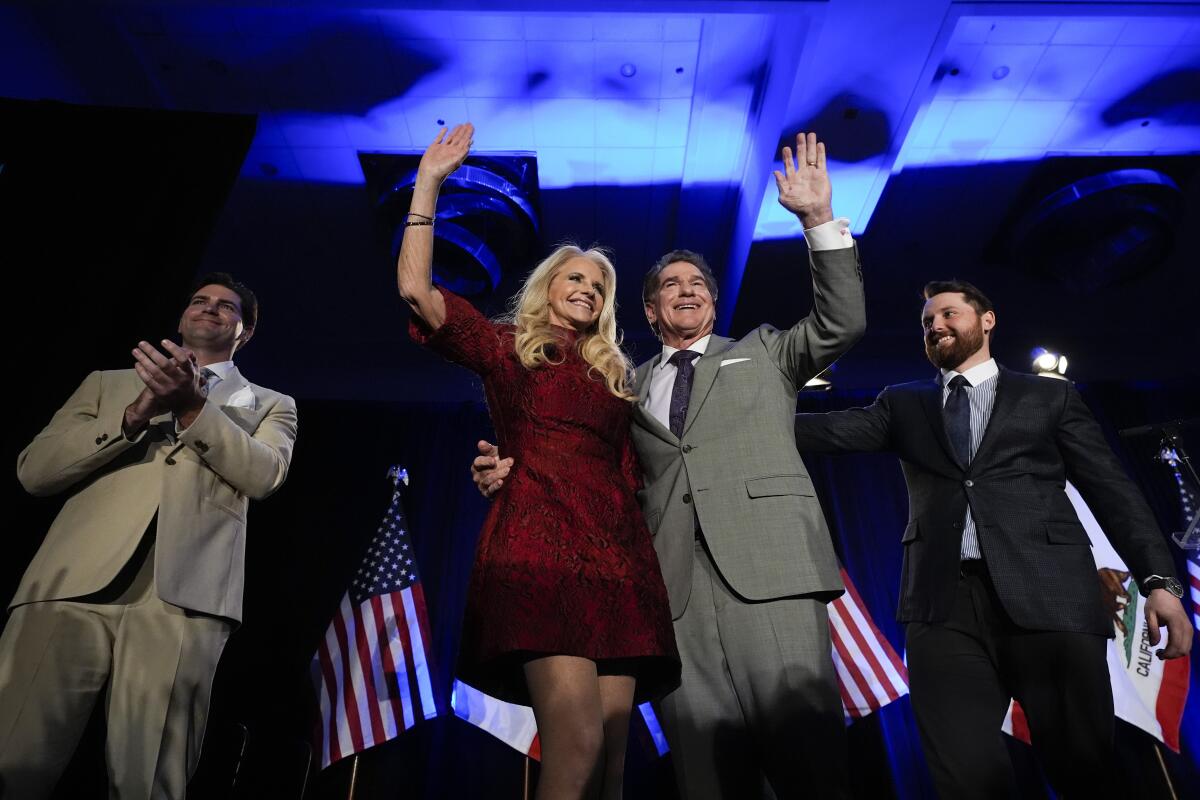 Republican U.S. Senate candidate Steve Garvey, center right, hugs his wife Candace standing next to his sons Ryan, left, and Sean during his election night party, Tuesday, March 5, 2024, in Palm Desert, Calif. (AP Photo/Gregory Bull)