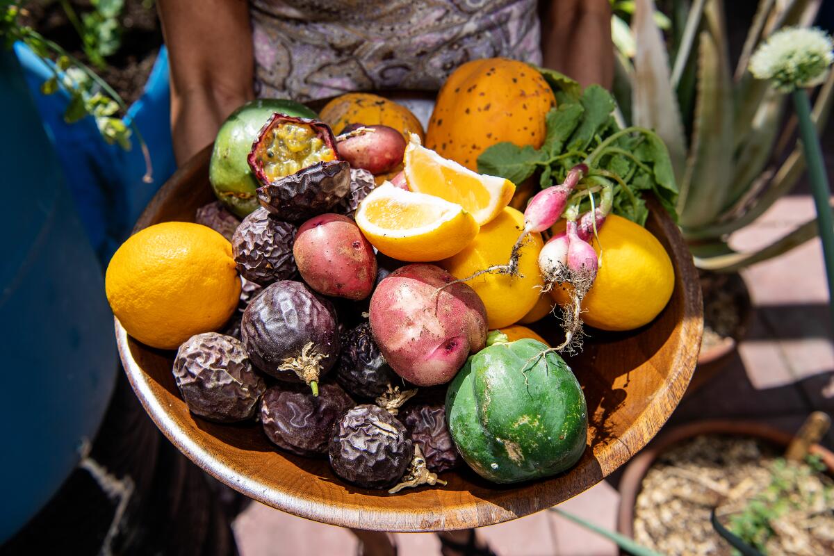 Passion fruit and lemons are among the fruits Thuy Tran grows in her Glendale garden.