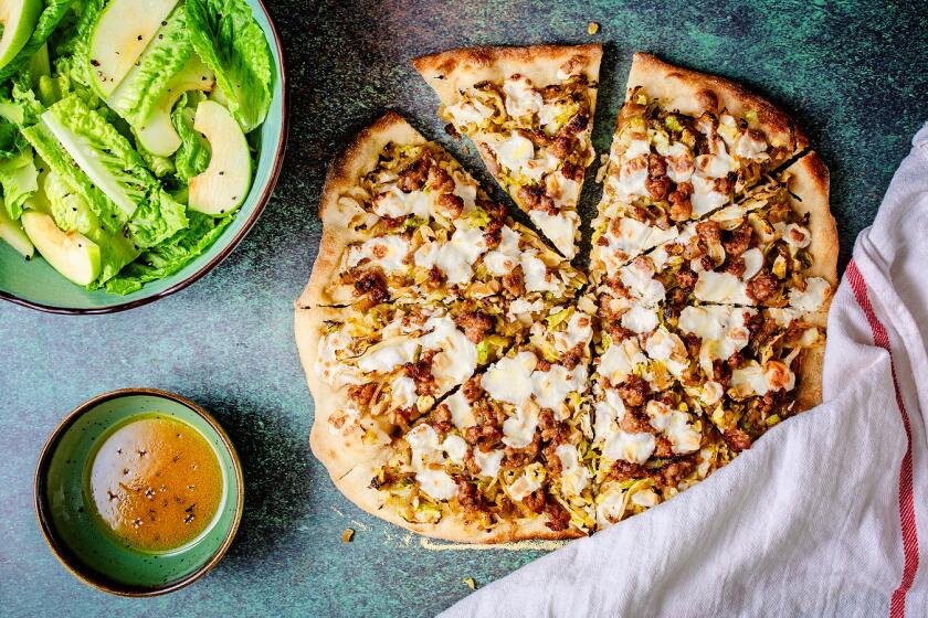 Sliced cabbage and sausage pizza with Romaine and apple salad on the side.