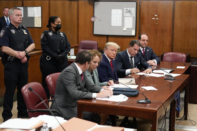 FILE - Former President Donald Trump, center, appears in court for his arraignment, Tuesday, April 4, 2023, in New York. A dozen Manhattan residents are soon to become the first Americans ever to sit in judgment of a former president charged with a crime. Jury selection is set to start Monday in former President Donald Trump's hush-money trial. (AP Photo/Seth Wenig, Pool)
