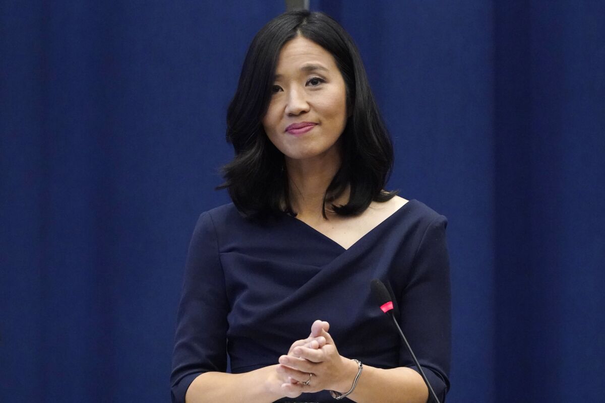 FILE - Boston Mayor Michelle Wu pauses during a ceremony at Boston City Hall, Nov. 16, 2021, in Boston. Wu, who has Taiwanese heritage, has faced what the city's elected officials of color condemned as "relentless threats of violence and hateful attacks" since she took office in November. Protests have been held almost daily outside her home, some starting in the early morning hours, with drums and bullhorns, and what fellow lawmakers described as "openly racist, anti-Asian and sexist rhetoric." (AP Photo/Charles Krupa, File)