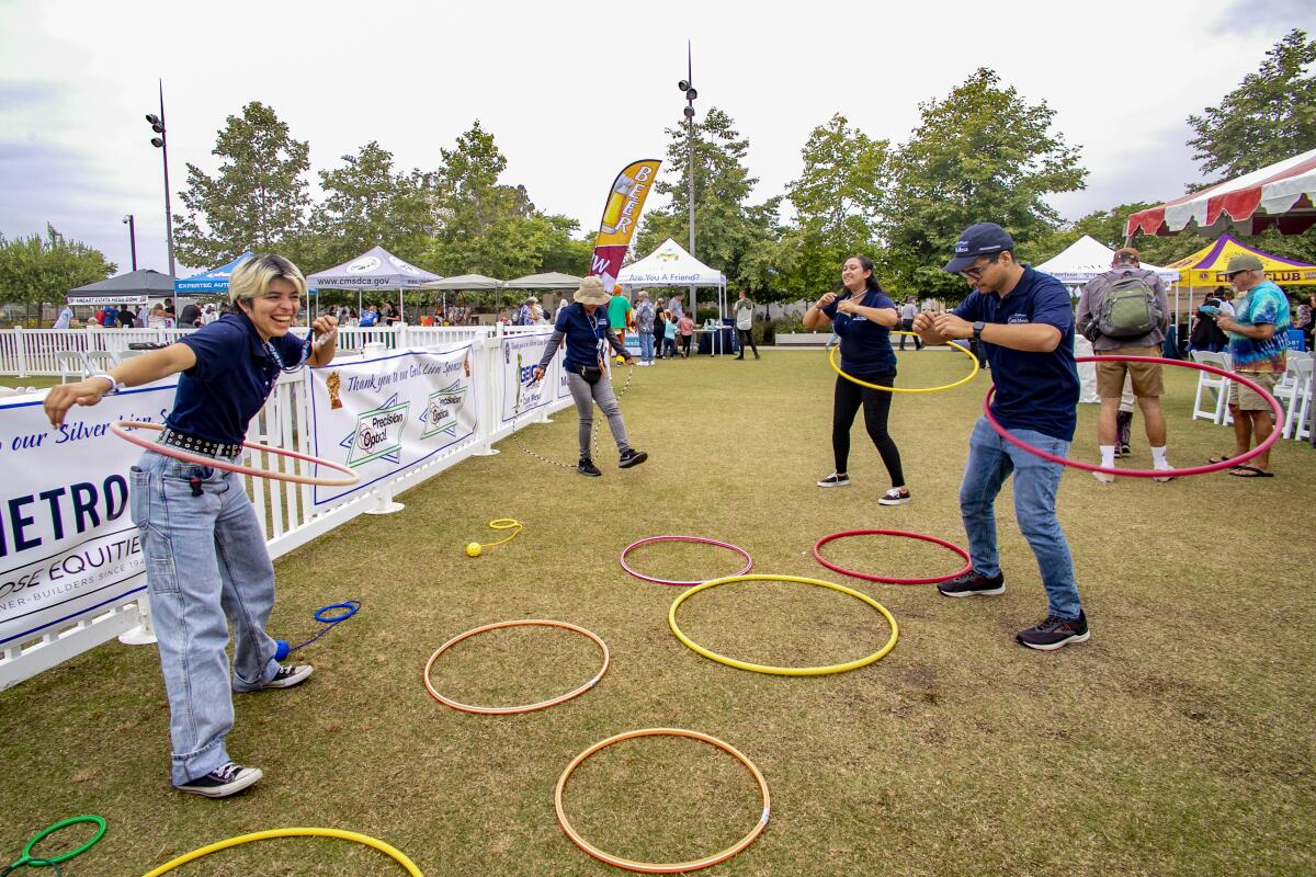 Costa Mesa city staffers Bella Espinoza, Julie Nguyen, Lizbeth Gomez and Vicente Martinez try out hula hoops and skip rope.