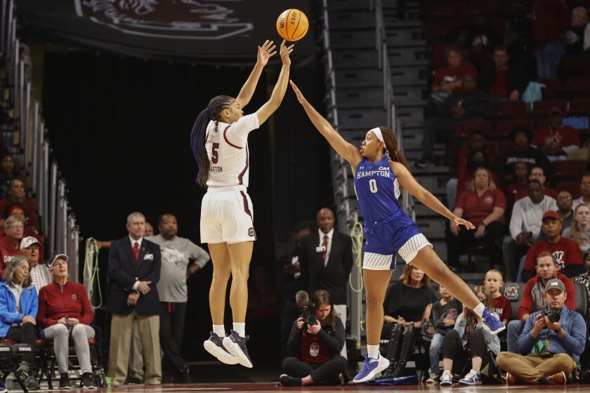 South Carolina forward Victaria Saxton, left, shoots over Hampton guard Camryn Hill during the first quarter of an NCAA college basketball game in Columbia, S.C., Sunday, Nov. 27, 2022. (AP Photo/Nell Redmond)