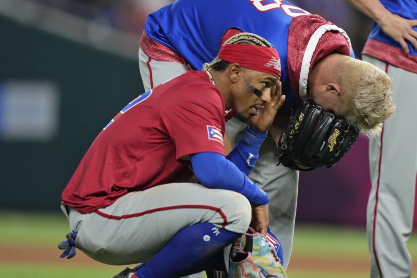 Puerto Rico players react after pitcher Edwin Diaz was injured during a postgame celebration 