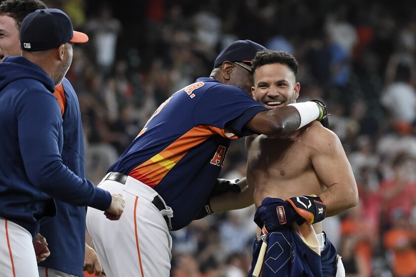Houston Astros' Jose Altuve, right, celebrates his winning three-run home run with manager Dusty Baker Jr., left, during the ninth inning of a baseball game against the New York Yankees, Sunday, July 11, 2021, in Houston. (AP Photo/Eric Christian Smith)