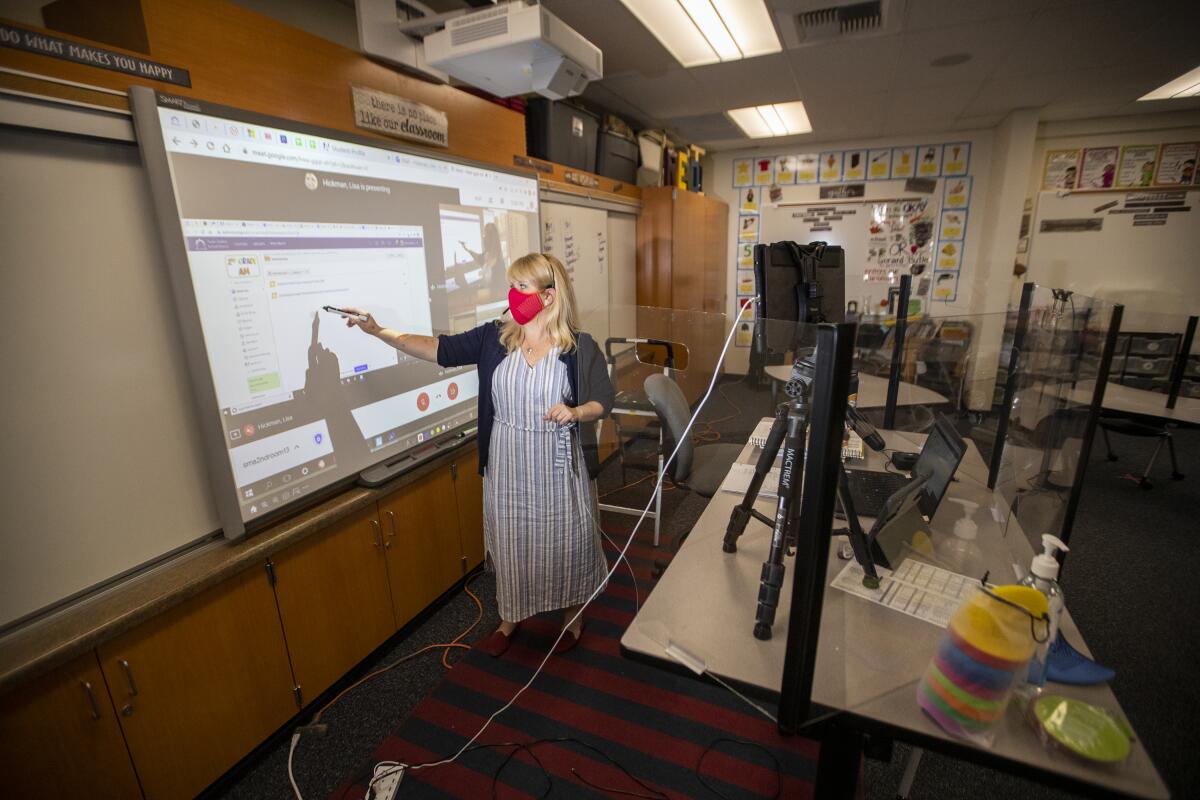 A second-grade teacher at Sycamore Magnet Academy in Tustin conducts a remote lesson on Sept. 23, 2020. 