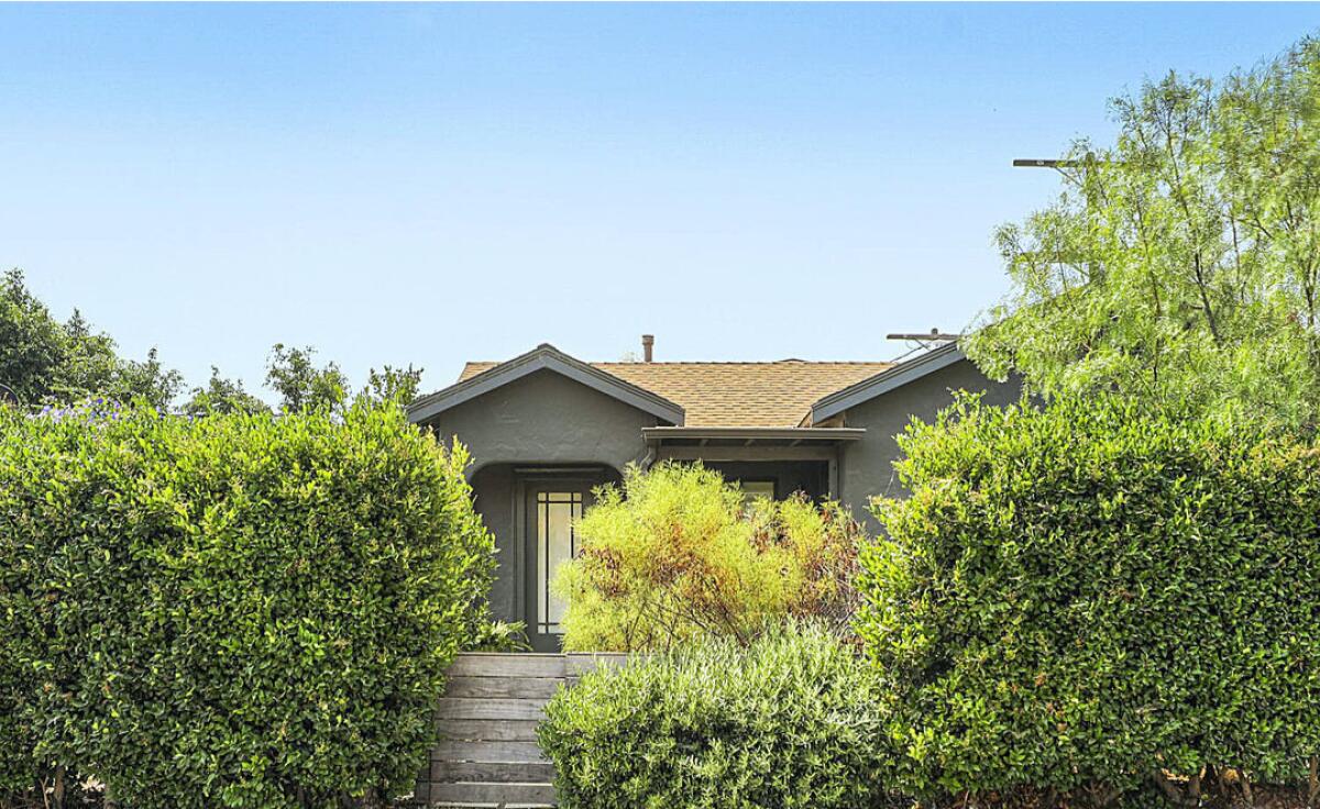 A home is surrounded by lush greenery.