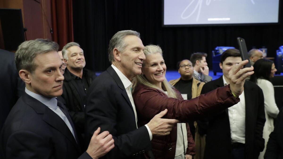 Former Starbucks CEO Howard Schultz poses for photos after speaking Thursday, Jan. 31, 2019.