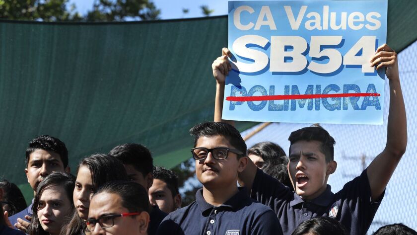 Students at a 2017 rally in Highland Park in support of SB 54. Federal authorities have cited the so-called sanctuary state measure in refusing to hand over some criminal suspects to state law enforcement officials.