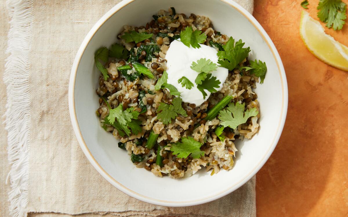 Grated cauliflower adds body to lentils and rice, topped with yogurt and cilantro leaves. Prop Styling by Kate Parisian.