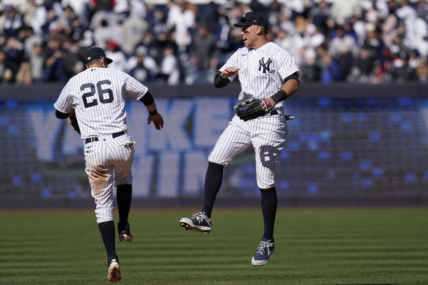 New York Yankees' Aaron Judge, right, and DJ LeMahieu (26) celebrate after a baseball game against the San Francisco Giants at Yankee Stadium Thursday, March 30, 2023, in New York. The Yankees defeated the Giants 5-0. (AP Photo/Seth Wenig)