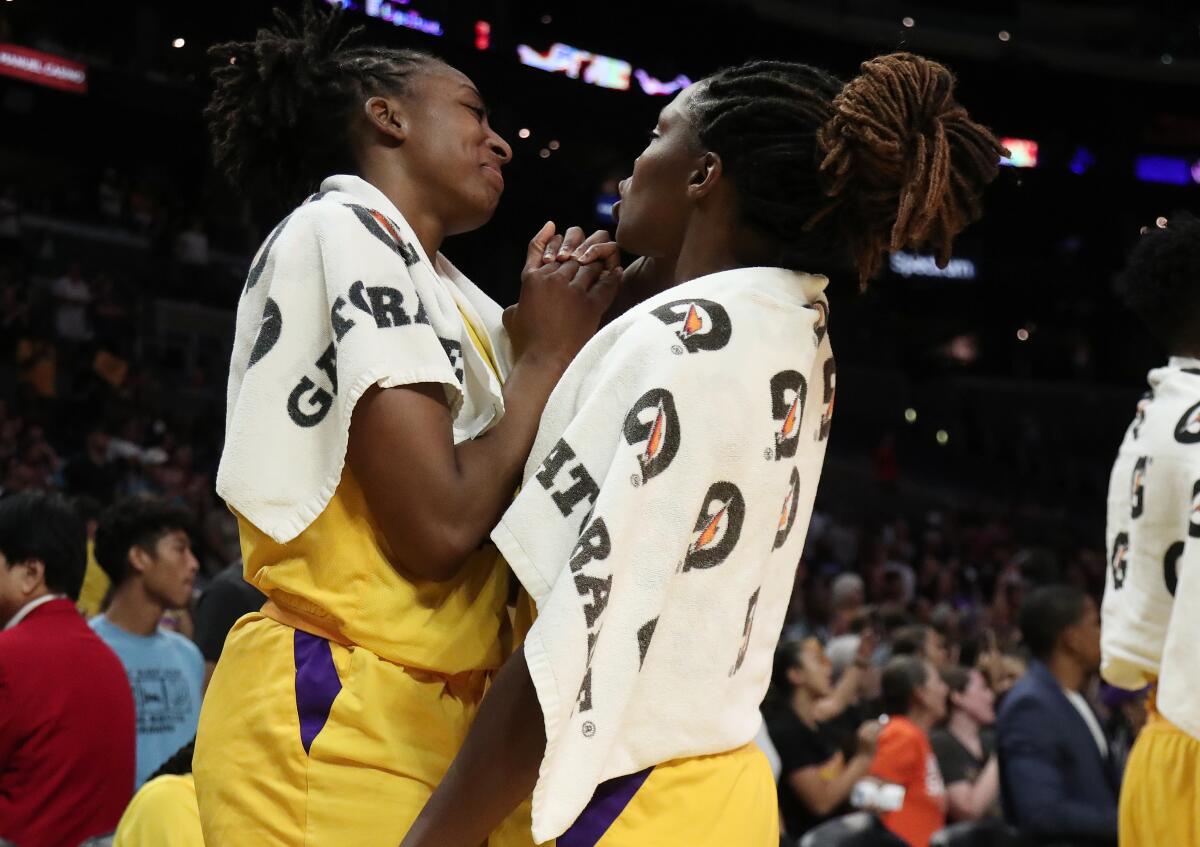 Sparks forward Nneka Ogwumike, left, and guard Chelsea Gray (12) celebrate after a win last season. 