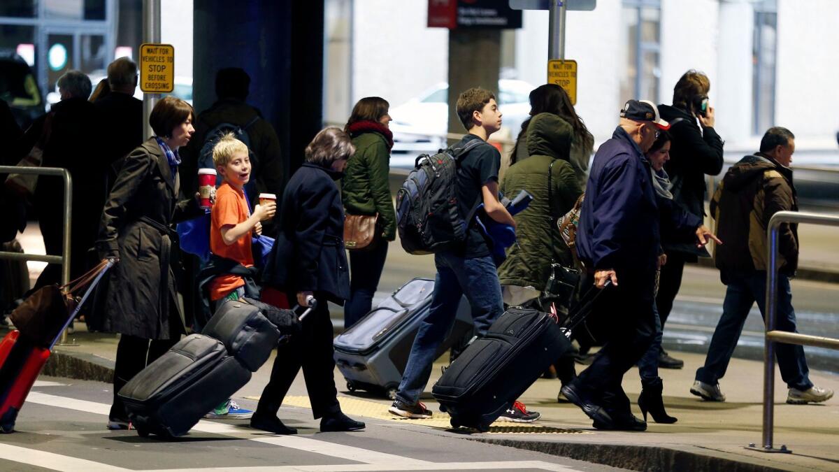 Passengers depart Logan International Airport in Boston. A program that promotes travel to the U.S., which is funded by fees charged to visitors, would be killed under President Trump's budget plan.
