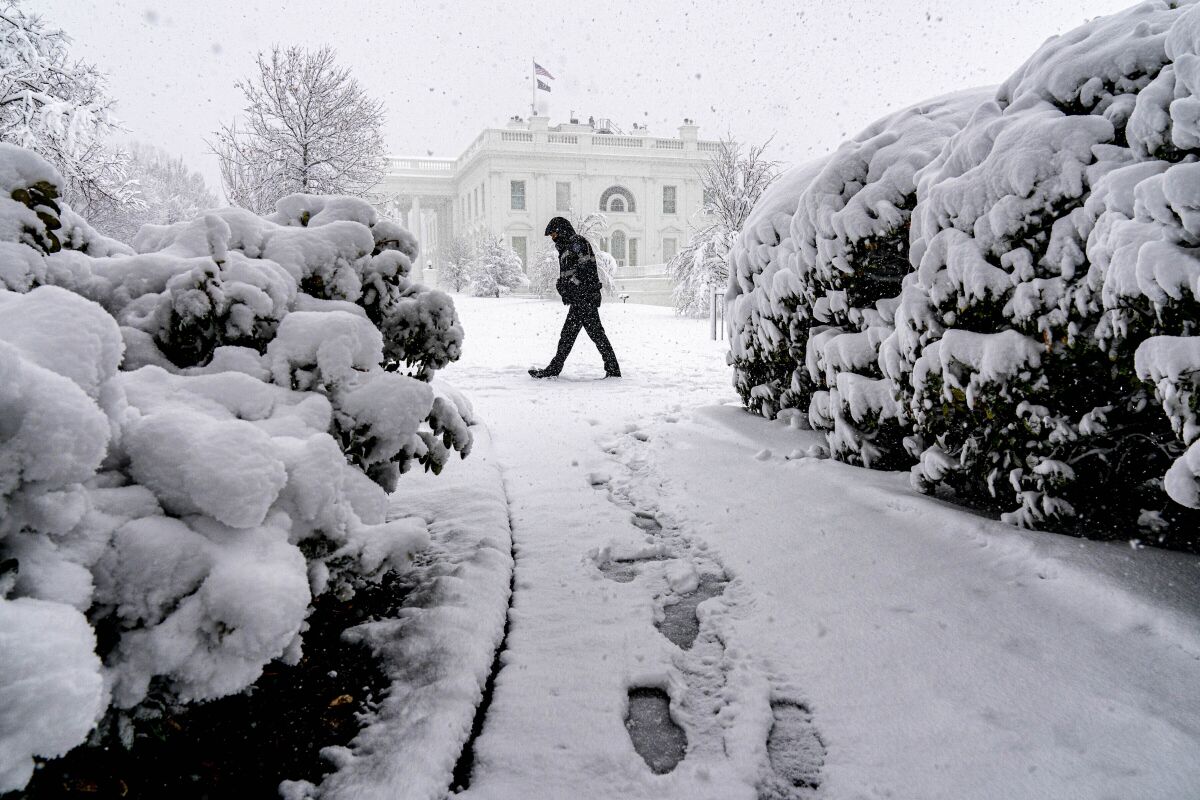 Snow falls at the White House in Washington, Monday, Jan. 3, 2022, as a winter storm blows into the Mid-Atlantic area. (AP Photo/Andrew Harnik)