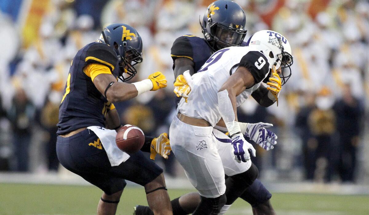 Texas Christian receiver Josh Doctson has the ball stripped from his grasp by West Virginia cornerback Terrell Chestnut in the third quarter Saturday.