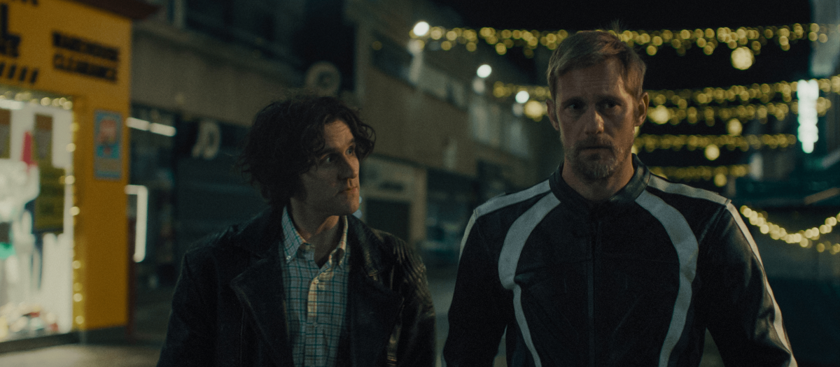 Two men have a conversation walking at night.
