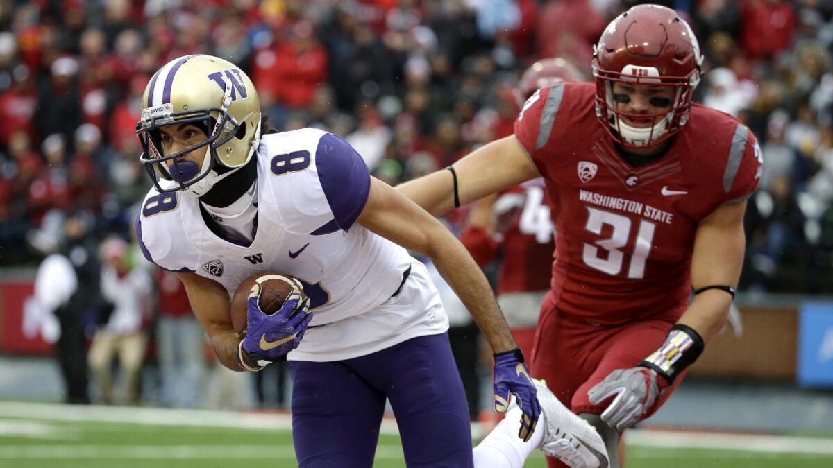 Washington receiver Dante Pettis makes a catch in front of Washington State linebacker Isaac Dotson for a touchdown in the first half Friday.