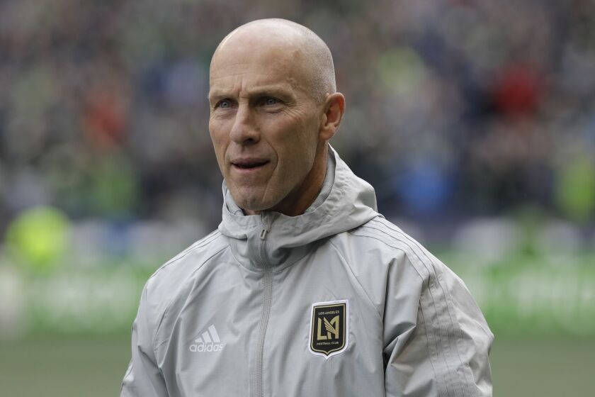 Los Angeles head coach Bob Bradley walks on the pitch before an MLS soccer match against the Seattle Sounders, Sunday, March 4, 2018, in Seattle. (AP Photo/Ted S. Warren)
