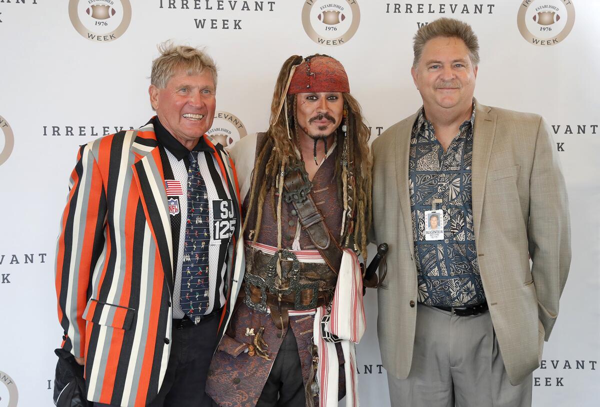 Laird Hayes, left, and author Rich Dunn flank a greeter dressed as Capt. Jack Sparrow during the 2021  Lowsman Banquet.