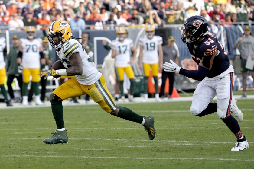 Green Bay Packers running back Aaron Jones heads for the end zone for a touchdown as Chicago Bears linebacker T.J. Edwards pursues during the second half of an NFL football game Sunday, Sept. 10, 2023, in Chicago. (AP Photo/Nam Y. Huh)