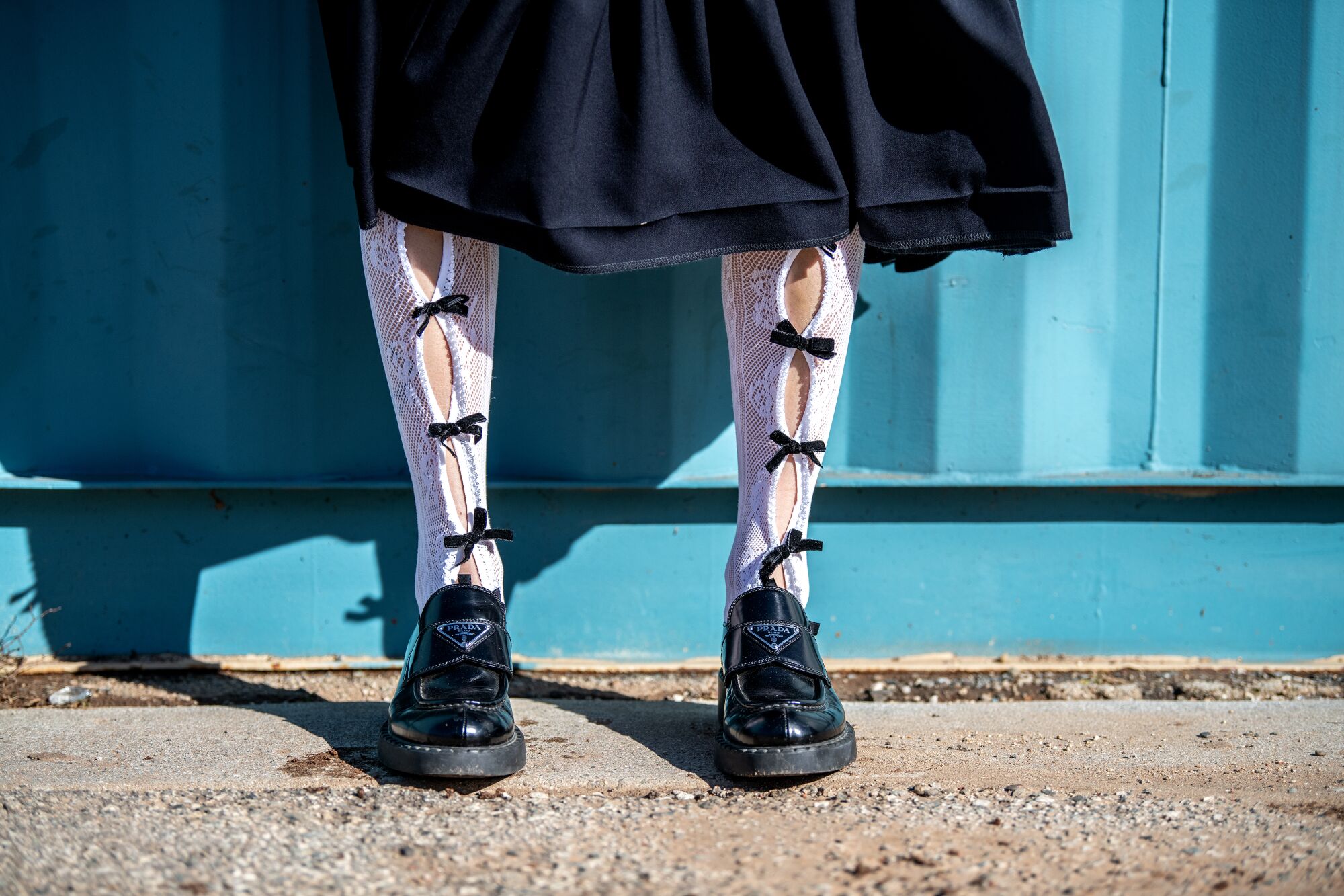 Qian says socks can "make or break a look." Here, Qian wears Nodress socks with Prada loafers and a CDG Girl skirt.