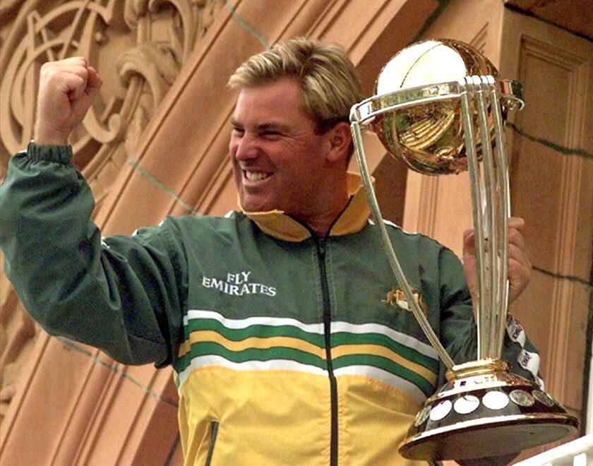 FILE - Australia's Shane Warne clenches his fist as he holds the Cricket World Cup Trophy on the team balcony at Lords after Australia defeated Pakistan by 8 wickets in the final of the Cricket World Cup, in London Sunday, June 20, 1999. Shane Warne, one of the greatest cricket players in history, has died. He was 52. Fox Sports television, which employed Warne as a commentator, quoted a family statement as saying he died of a suspected heart attack in Koh Samui, Thailand. (AP Photo/Rui Vieira, File)