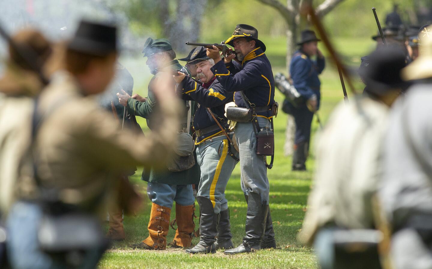 Union army soldiers fire at Confederate army soldiers during a battle at the 24th annual Civil War Days Living History Event in Huntington Beach Central Park on Saturday, September 1.