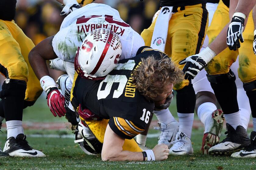 Iowa quarterback C.J. Beathard loses his helmet as he's sacked by Stanford linebacker Peter Kalambayi in the second quarter.