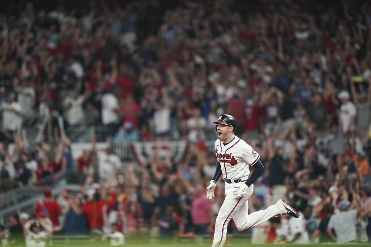 Atlanta Braves' Freddie Freeman (5) celebrates his home run during the eighth inning of Game 4.