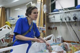 Pediatrician Tanya Haj-Hassan, examines wounded Gazan children at Al-Aqsa Martyrs Hospital in Deir al-Balah, central Gaza. Saturday, March 16, 2024. (AP Photo/Abdel Kareem Hana)