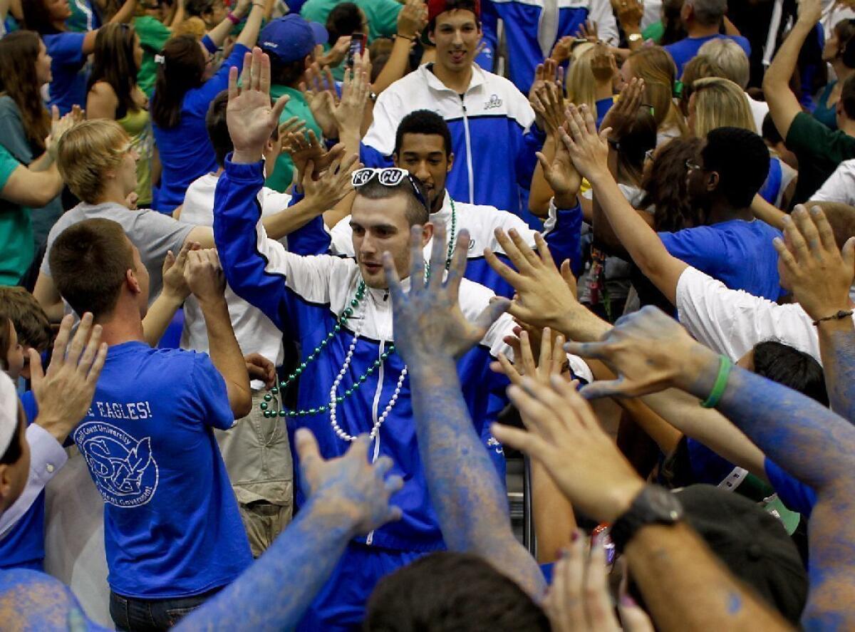 Fans greet the Florida Gulf Coast men's basketball team as they make their way to the court.