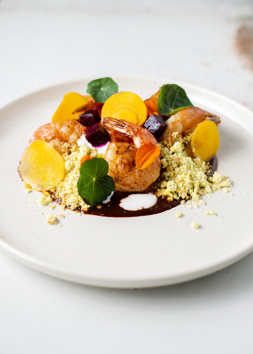 Pan-seared shrimp mole with roasted red beets, lime crema, and tortilla chip-cilantro persillade.