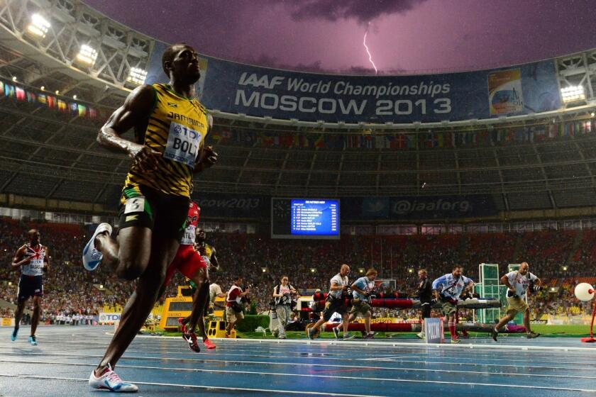 A bolt of lightning strikes just after Jamaican sprinter Usain Bolt wins the 100-meter title at the IAAF world championships in Moscow.