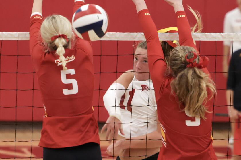 SAN DIEGO, CA - SEPTEMBER 06, 2023: Torrey Pines' Finley Krystkowiak hits the ball past Cathedral Catholic's Jenna Hanes, left, and Madyson McCarthy during the fourth game at Torrey Pines High School in San Diego on Wednesday, September 06, 2023. (Hayne Palmour IV / For The San Diego Union-Tribune)