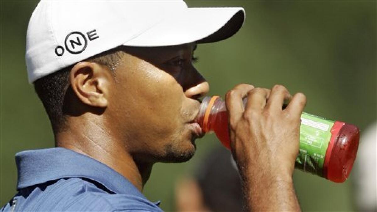 FILE - This is an Aug. 15, 2006, file photo showing Tiger Woods taking a drink of Gatorade on the driving range after his practice round for the 88th PGA Championship, in Medinah, Ill. A year has passed since the infamous crash that started it all, and Woods appears ready to re-enter the marketing game. (AP Photo/Lenny Ignelzi, File)